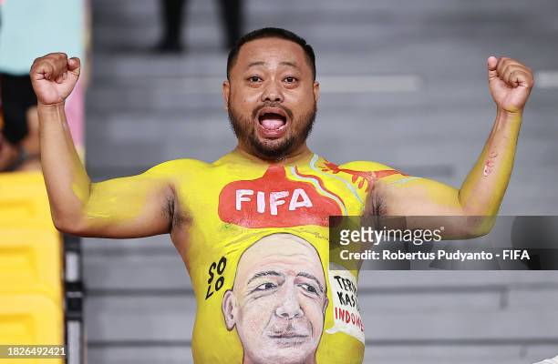 Fan with poses for a photo with a painting of Gianni Infantino on his stomach during the FIFA U-17 World Cup Final match between Germany and France...
