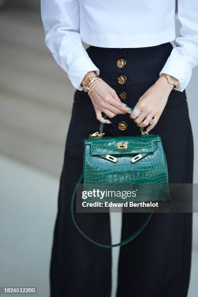 Heart Evangelista wears a green shiny crocodile leather Kelly Hermes bag, during a street style fashion photo session, on December 02, 2023 in...
