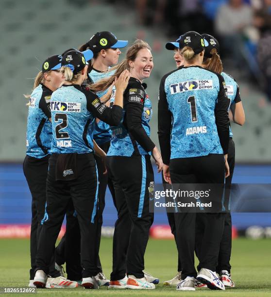 Amanda-Jade Wellington of the Adelaide Strikers with team mates after the wicket of Georgia Redmayne of the Brisbane Heat for 22 runs caught by...