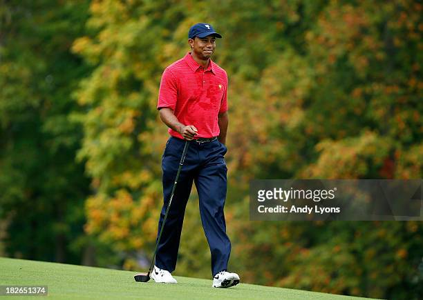 Tiger Woods of the U.S. Team walks down a fairway during a practice round prior to the start of The Presidents Cup at the Muirfield Village Golf Club...