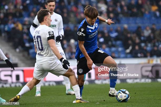 Mirnes Pepic of Aue tackles Kaito Mizuta of Bielefeld during the 3. Liga match between Arminia Bielefeld and Erzgebirge Aue at Schueco Arena on...