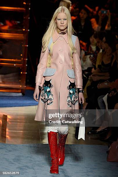 Model walks the runway at the Miu Miu Spring Summer 2014 fashion show during Paris Fashion Week on October 2, 2013 in Paris, France.