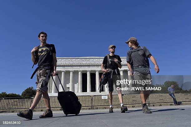 French tourists Alexis Ruimy , Lorris Hahn and Jeremy Hodoli visit the closed Lincoln Memorial in Washington, DC, on October 2 second day of the...