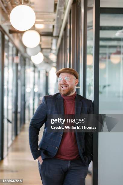 portrait of modern businessman laughing - mittelalter mann stock-fotos und bilder