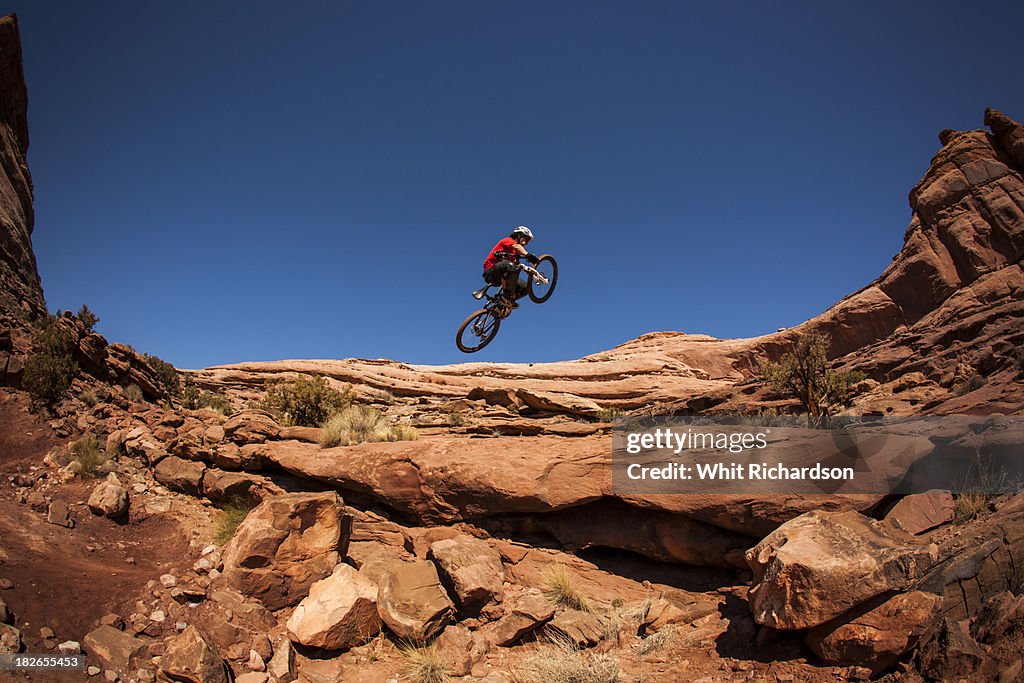 A man getting air on a jump on his montain bike near Moab, Utah.