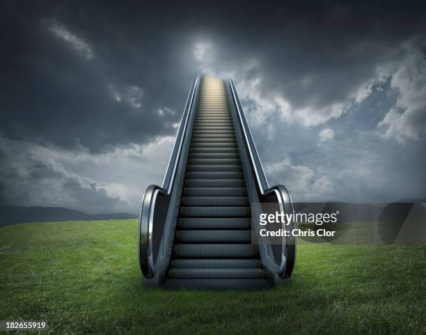 escalator to cloudy sky in rural landscape - 天国　階段 ストックフォトと画像