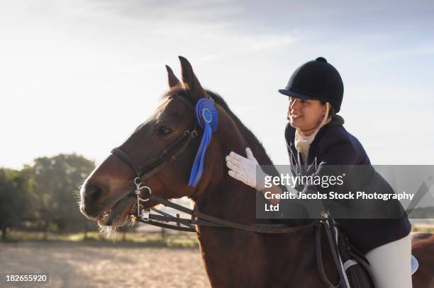 caucasian girl and horse winning equestrian competition - recreational horse riding stock pictures, royalty-free photos & images