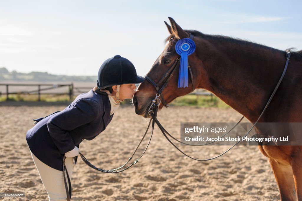 Caucasian girl and horse winning equestrian competition