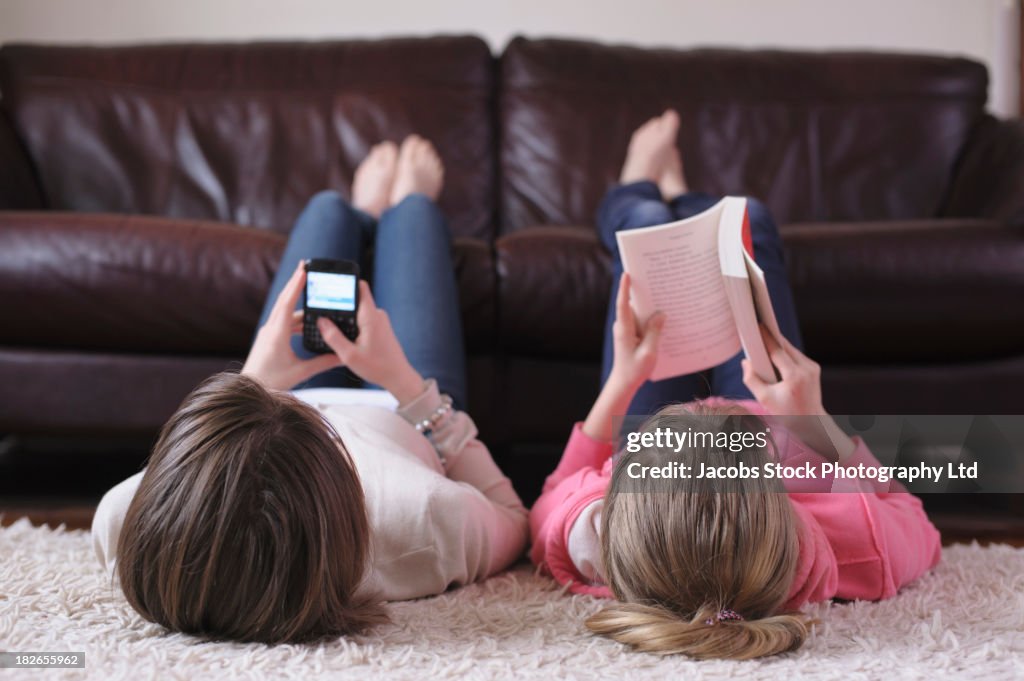 Caucasian girls relaxing together in living room