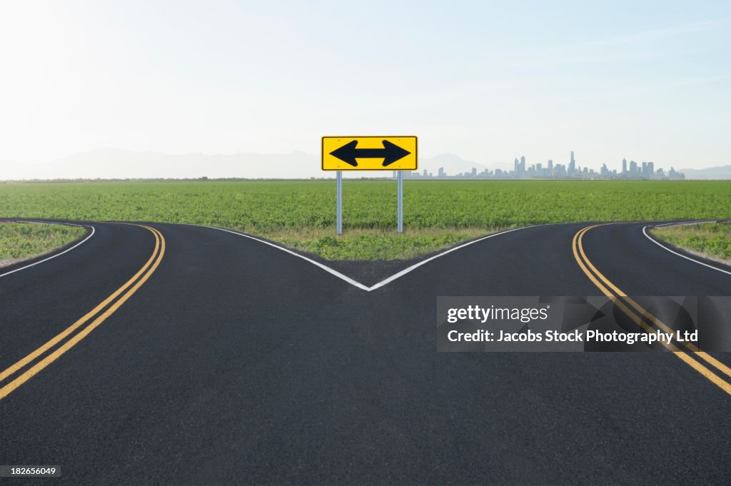 Double arrow road sign at fork, Denver, Colorado, United States