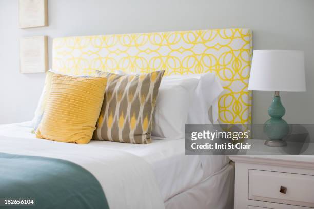 bed and nightstand in modern bedroom - bedding stock-fotos und bilder