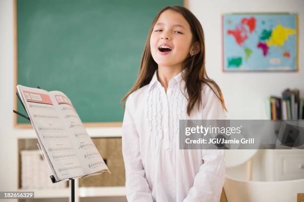 mixed race girl in singing class - singing imagens e fotografias de stock