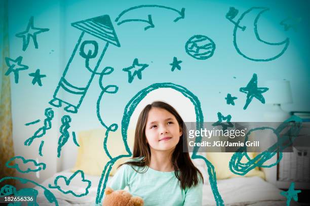 mixed race girl with space doodles surrounding head - niños pensando fotografías e imágenes de stock