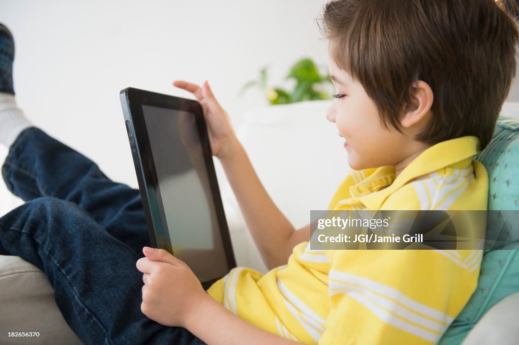 Hispanic boy using tablet computer