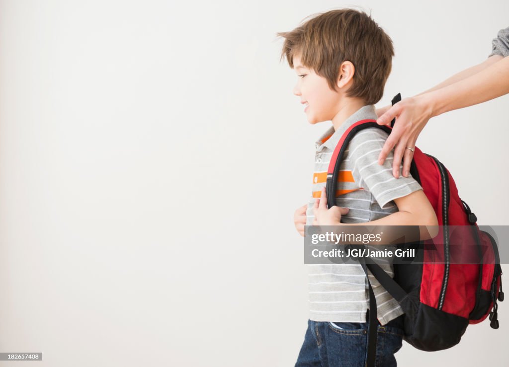 Hispanic mother rushing son to school