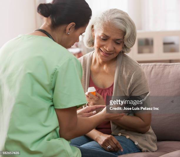 nurse and older patient using tablet computer - digital health display stock pictures, royalty-free photos & images