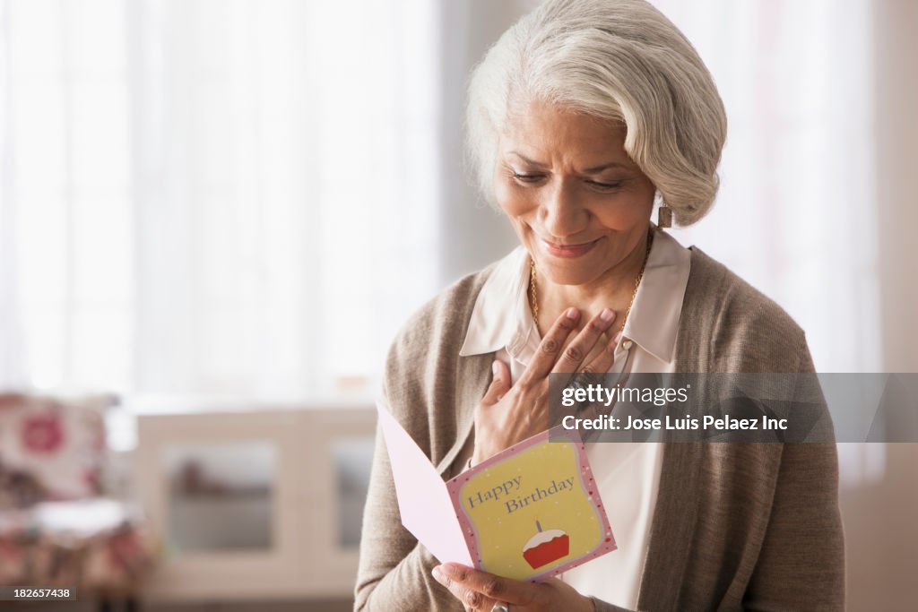 Older African American woman reading birthday card