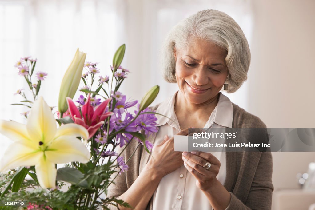 Older Black woman receiving bouquet of flowers