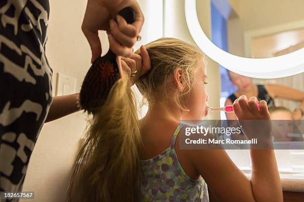 caucasian mother brushing daughter's hair - brushed back hair stock pictures, royalty-free photos & images