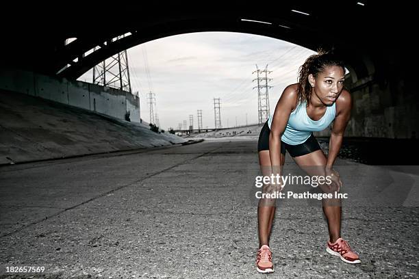 african american runner resting under overpass - fatigue full body stock pictures, royalty-free photos & images