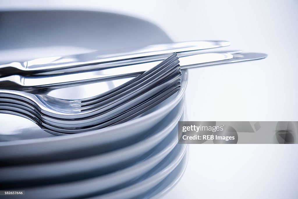 Close up of silverware and stacked plates