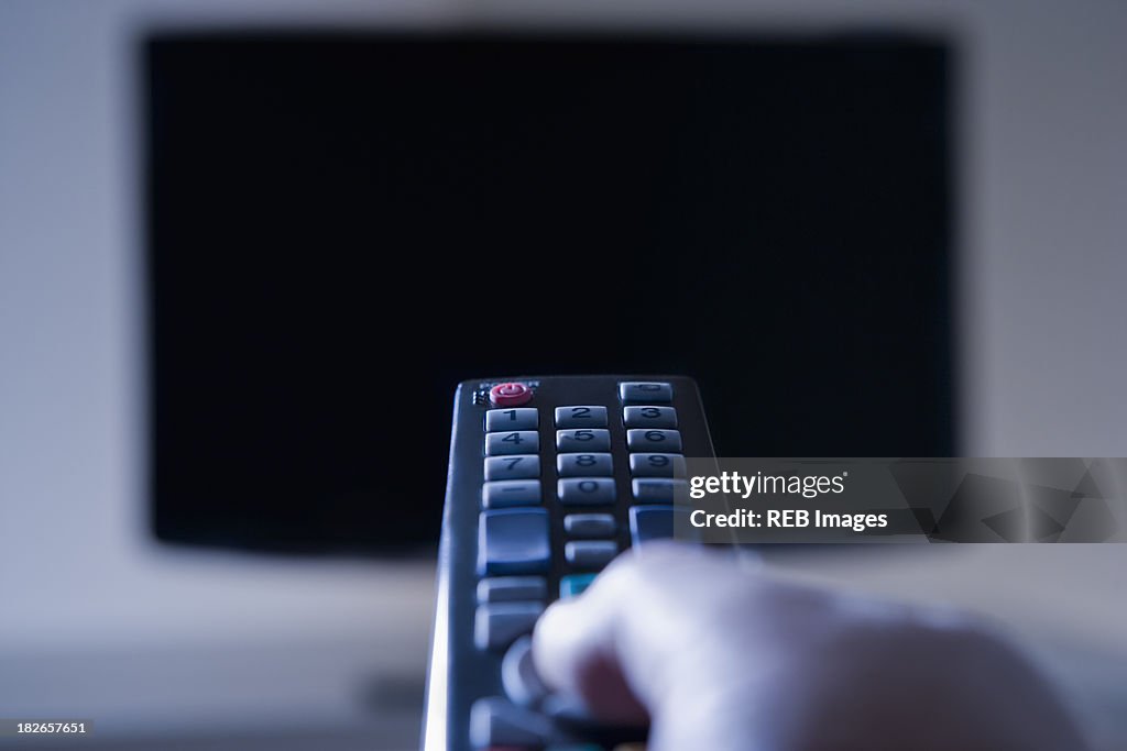 Hispanic man using remote control