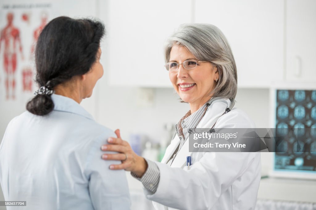 Doctor talking with patient in office