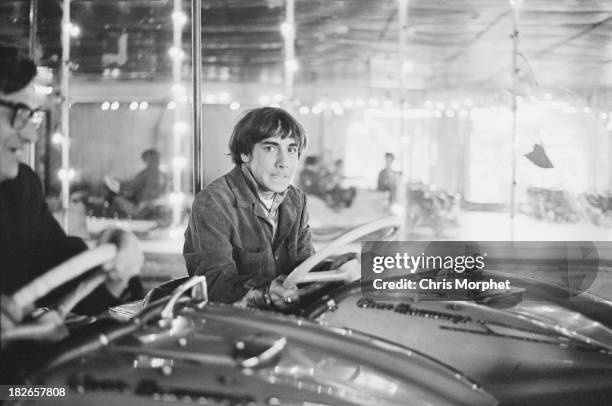 Drummer Keith Moon , of English rock group The Who, driving a dodgem car at a funfair in Felixstowe, Suffolk, before a concert, 9th September 1966.