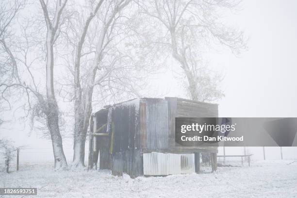 Derelict barn sits in the fog and snow at Mill Farm on December 02, 2023 in Bodsham, United Kingdom. The UK Met Office have warned of snow, ice and...