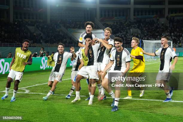 Almugera Kabar of Germany celebrates with teammates after scoring the winning penalty in the penalty shoot out following the FIFA U-17 World Cup...