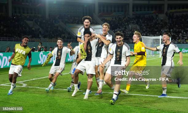 Almugera Kabar of Germany celebrates with teammates after scoring the winning penalty in the penalty shoot out following the FIFA U-17 World Cup...