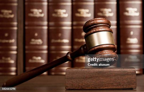 gavel on wooden desk with books as background - law stock pictures, royalty-free photos & images