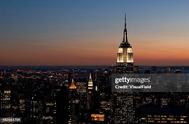 aerial view of empire state building & lower manhattan at sunset - rockefeller stock pictures, royalty-free photos & images