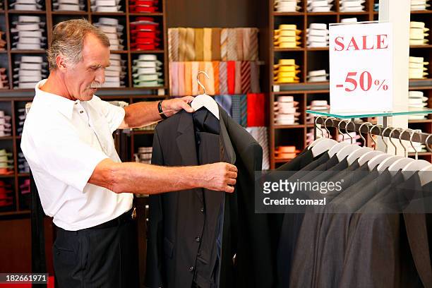 older man shopping for a suit - suit rack stock pictures, royalty-free photos & images