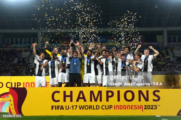 Christian Wueck, Head Coach of Germany, lifts the FIFA U-17 World Cup winners trophy following victory in the FIFA U-17 World Cup Final match between...