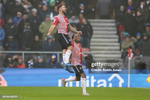 Kyle Walker-Peters of Southampton rushes to congratulate team-mate Adam Armstrong after he scores a goal to make it 1-0 during the Sky Bet...