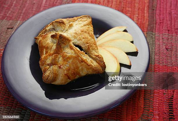 apple dumpling presented on a purple plate  - strudel stock pictures, royalty-free photos & images