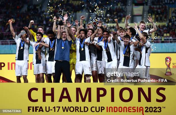 Christian Wueck, Head Coach of Germany, lifts the FIFA U-17 World Cup winners trophy following victory in the FIFA U-17 World Cup Final match between...