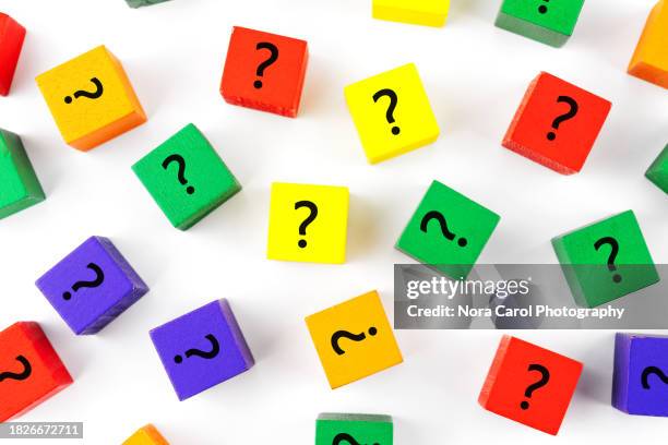 question marks on colorful wood block on white background - questions stock pictures, royalty-free photos & images