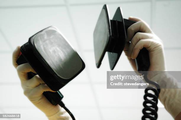 gloved hands holding a defibrillator in the air - stevedangers stock pictures, royalty-free photos & images