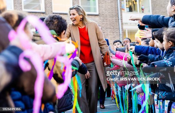 Dutch Queen Maxima greets children during her visit to the Rotterdam primary school De Bavokring for the program More Art and Culture in School and...