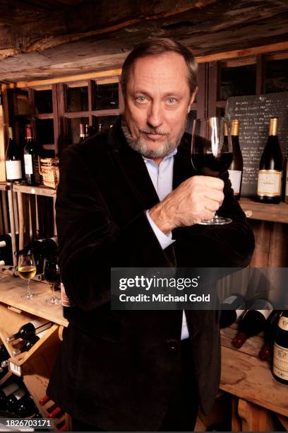 Wine expert, author, educator and lecturer, Kevin Zraly, holding a glass of red wine in the Depuis Canal House Restaurant in High Falls, NY, circa...