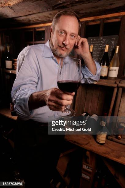 Wine expert, author, educator and lecturer, Kevin Zraly, holding a glass of red wine in the Depuis Canal House Restaurant in High Falls, NY, circa...