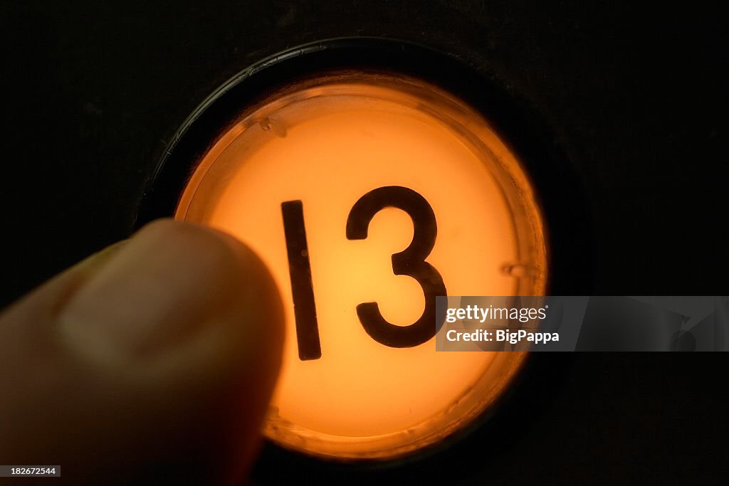 Finger pushing floor 13 elevator button