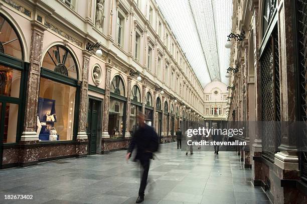 people walking quickly through galaries st hubert - brussels stock pictures, royalty-free photos & images