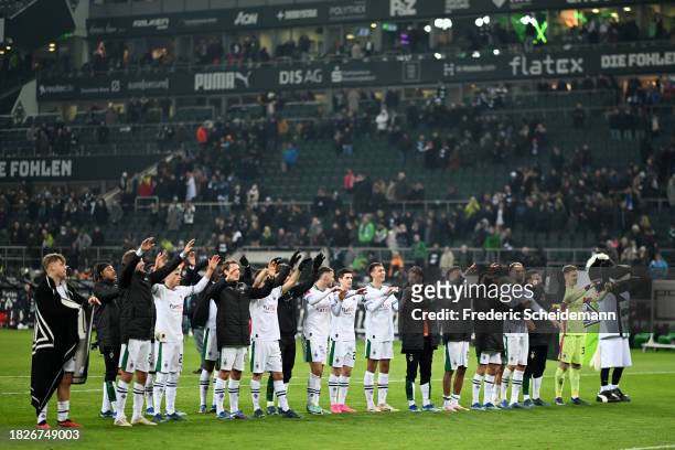 Borussia Moenchengladbach players celebrate with the fans following the team's victory during the Bundesliga match between Borussia Mönchengladbach...