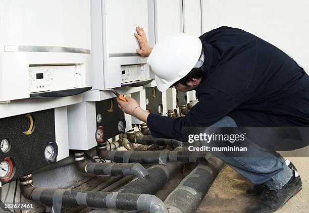 plumber in the process of a repair - heating engineer stock pictures, royalty-free photos & images