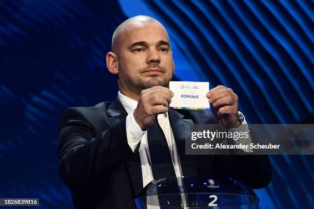 Special guest Wesley Sneijder​​ pulls out the card of Romania during the UEFA EURO 2024 Final Tournament Draw at Elbphilharmonie on December 02, 2023...