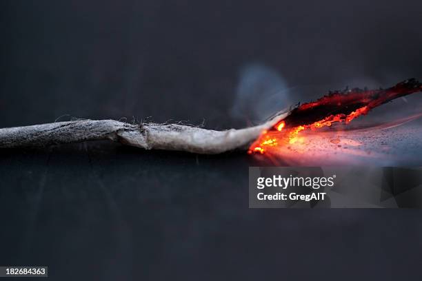 lit fuse burning on a dark background - burning fuse stock pictures, royalty-free photos & images