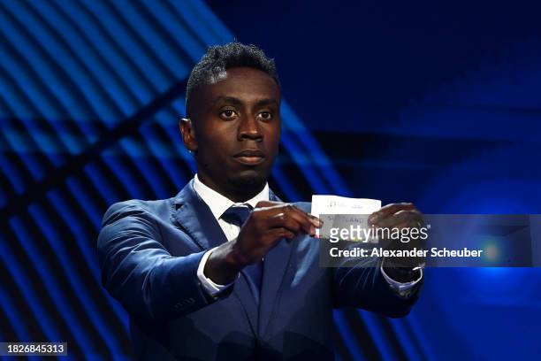 Special guest Blaise Matuidi​​​ pulls out the card of Scotland during the UEFA EURO 2024 Final Tournament Draw at Elbphilharmonie on December 02,...